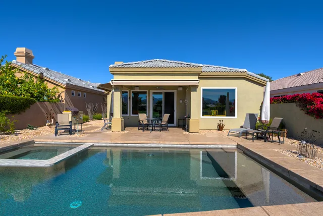 a house with palm tree in front of it
