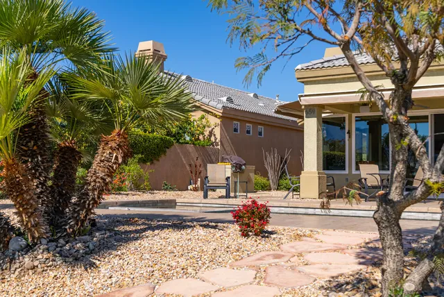 a view of a house with backyard porch and sitting area