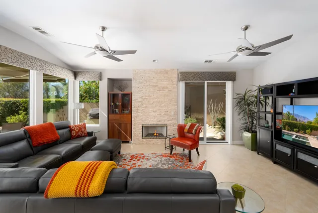 a living room with furniture fireplace and flat screen tv