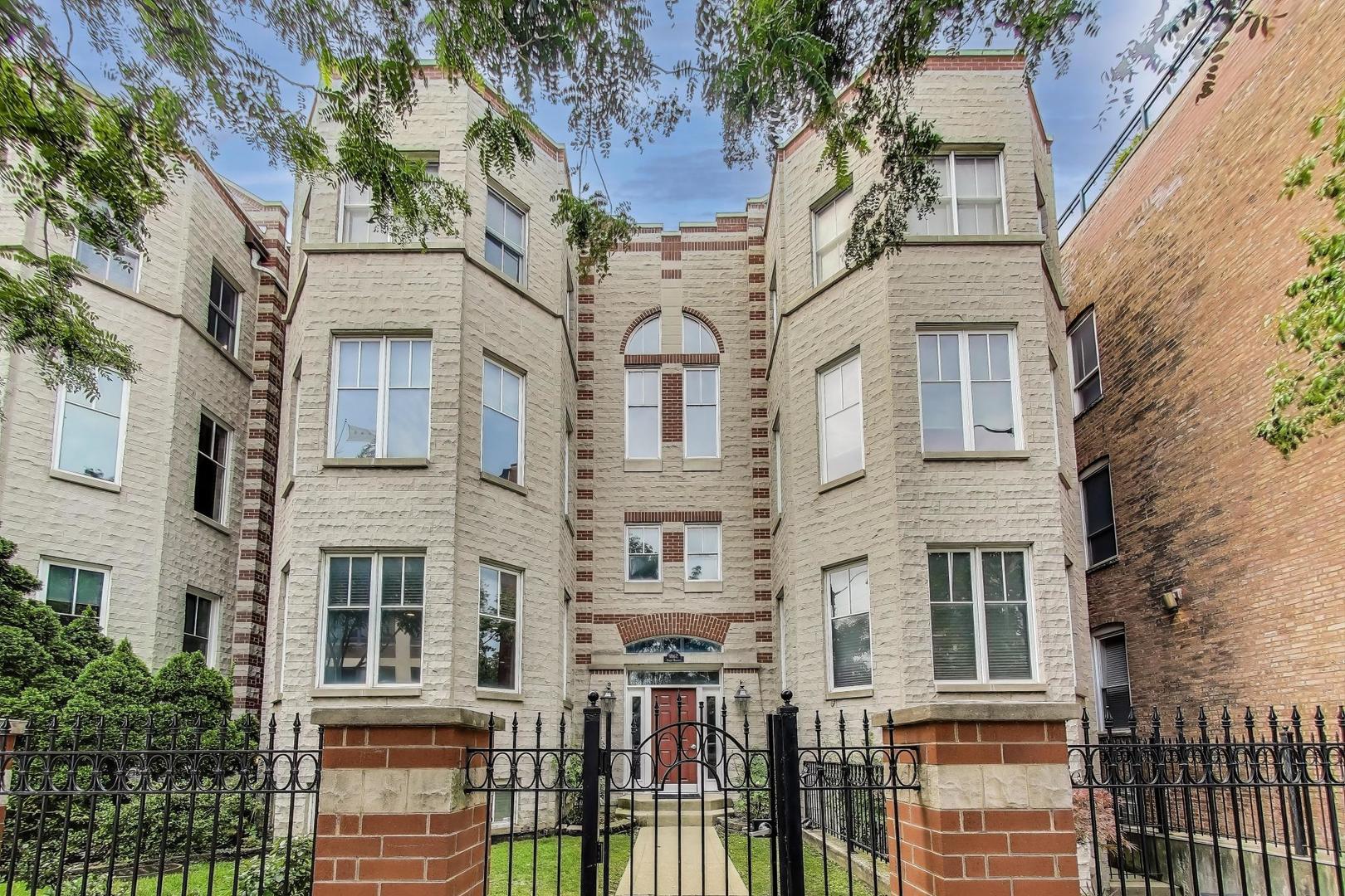 front view of a brick house with a large windows