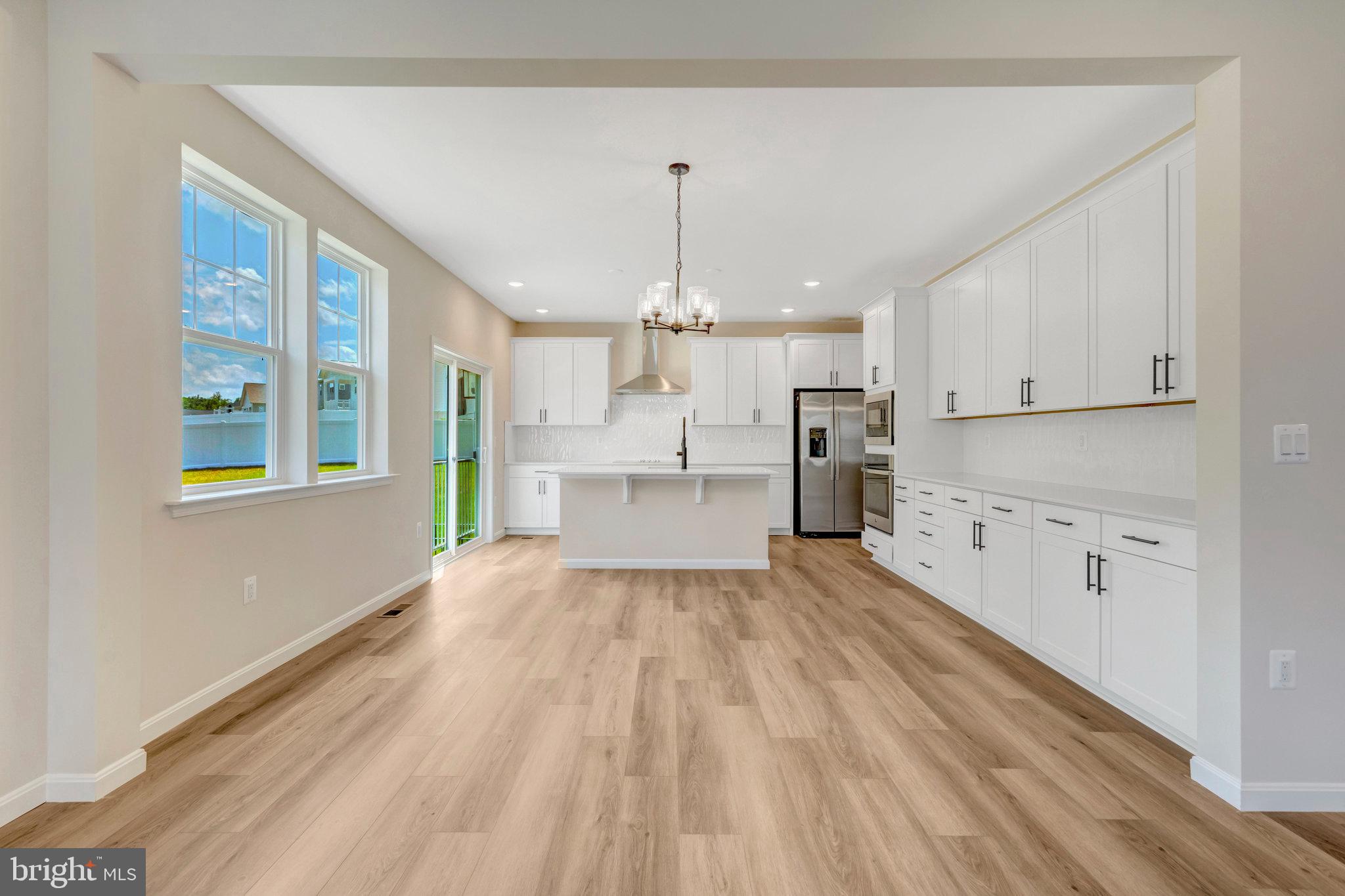 35670 Aspen Way Locust Grove, VA 22508 - Photo 13 of 60 a kitchen with stainless steel appliances granite countertop a refrigerator oven a sink dishwasher and white cabinets with wooden floor