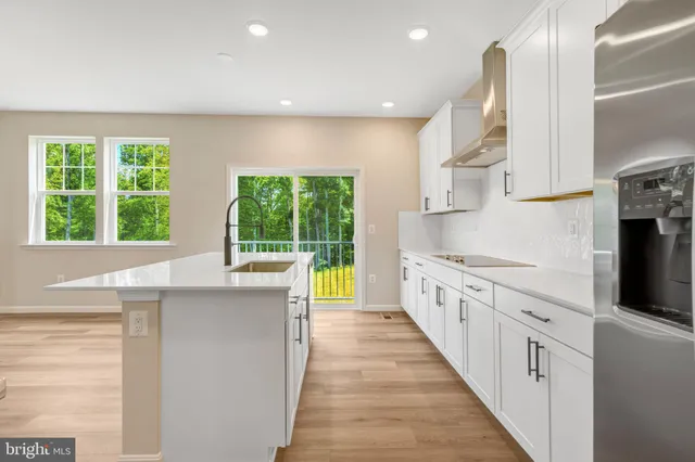 a kitchen with a sink cabinets and wooden floor
