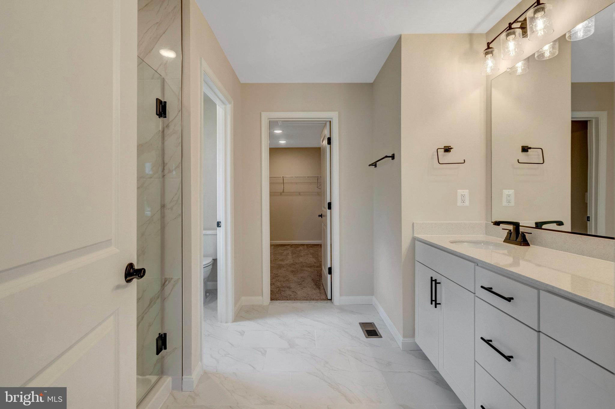 35670 Aspen Way Locust Grove, VA 22508 - Photo 37 of 60 a bathroom with a granite countertop sink mirror and shower