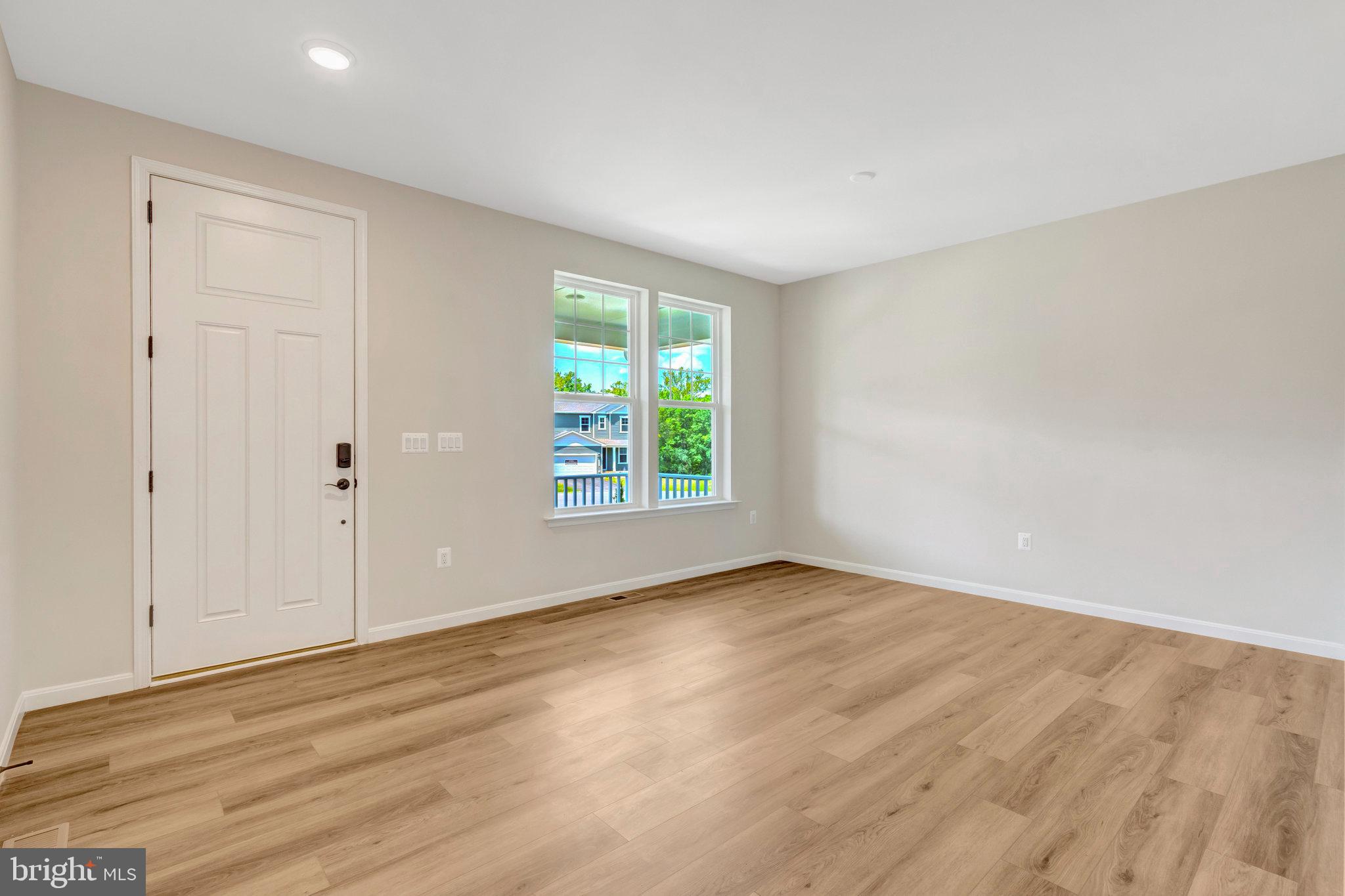 35670 Aspen Way Locust Grove, VA 22508 - Photo 7 of 60 a view of an empty room with wooden floor and a window