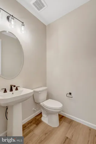 a view of room with wooden floor and stairs