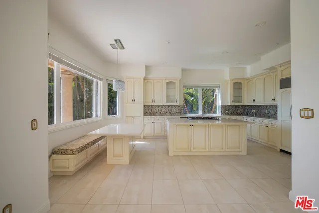 a view of a hallway with wooden floor and a bathroom