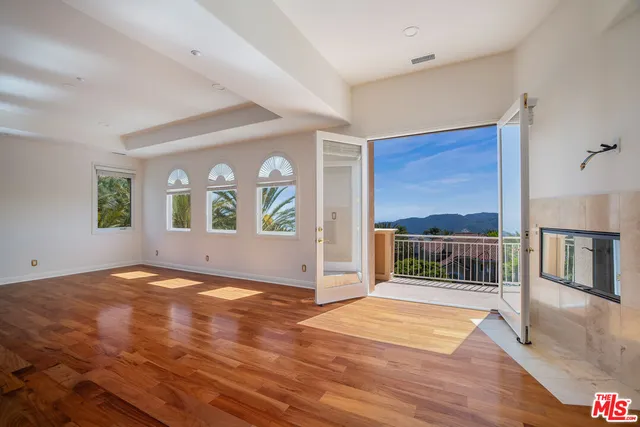 a bedroom with a large bed and a flat screen tv