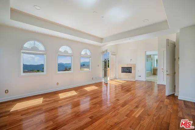 a spacious bathroom with a granite countertop sink and a bathtub