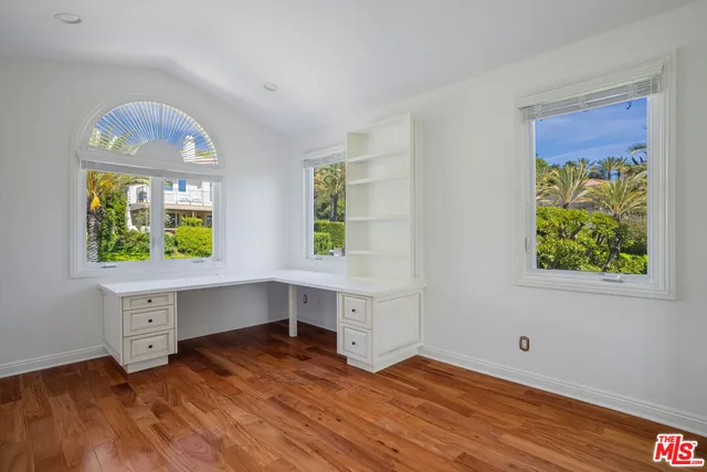 a spacious bedroom with a bed and a large window