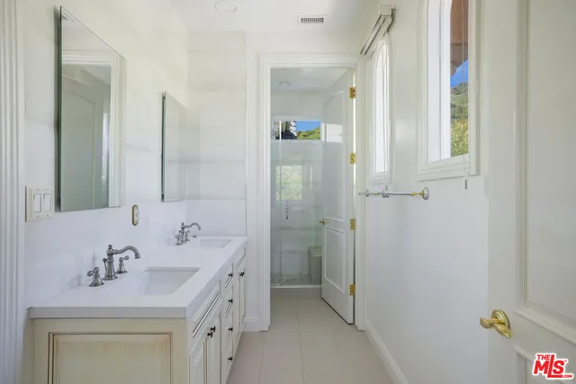 a bedroom with bed and window