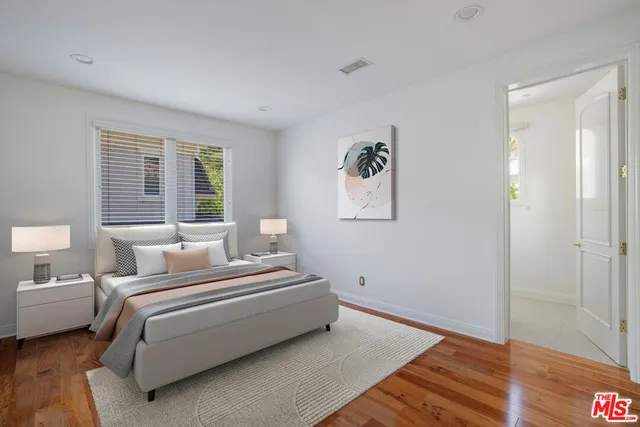 a spacious bathroom with double sink a mirror and a shower