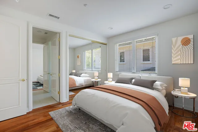 a view of a white house with a yard and potted plants