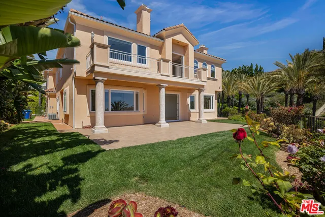 an aerial view of a tennis ground and a cars park
