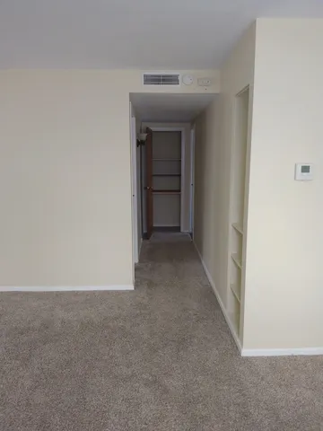 a view of an empty room and a window