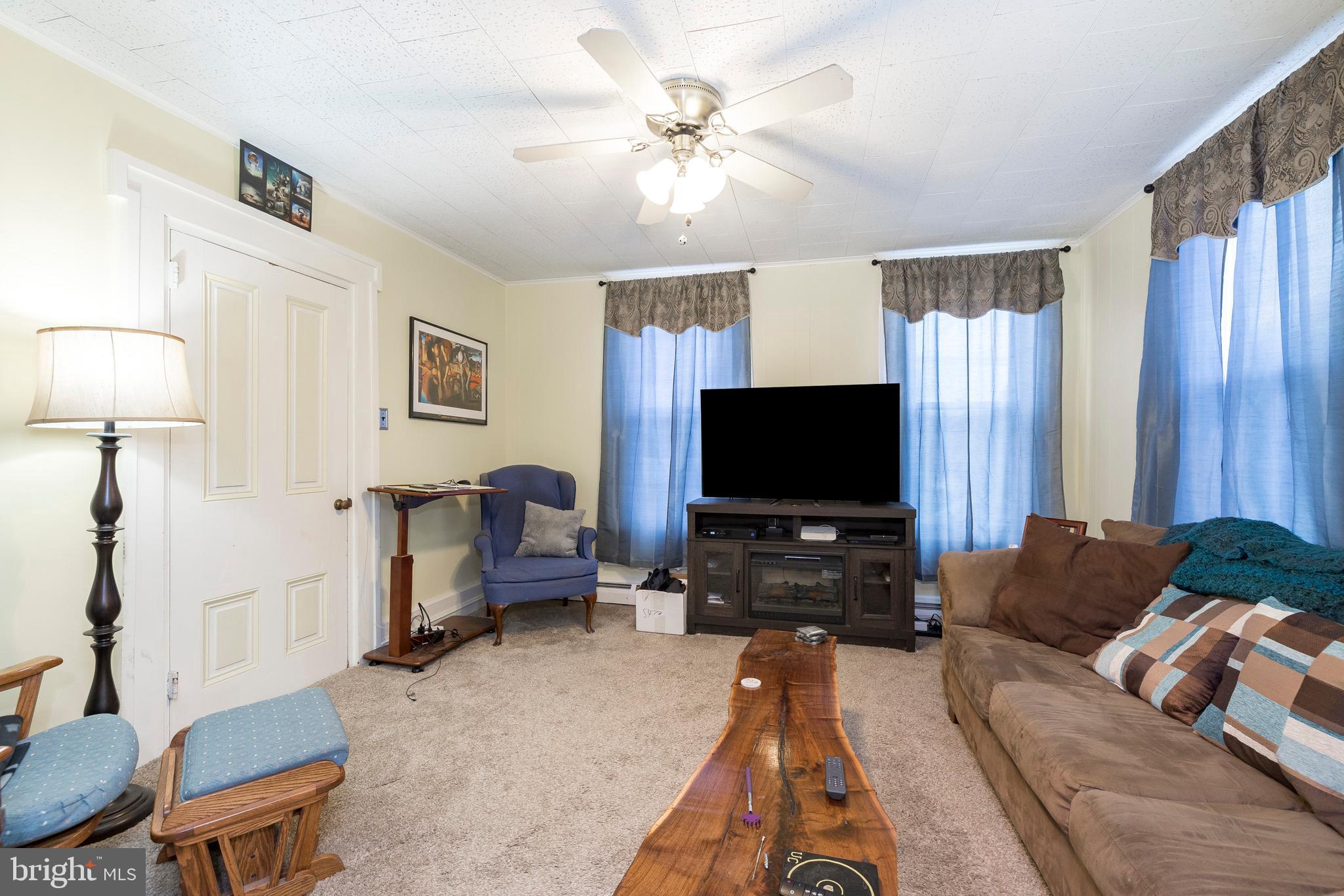 128 Chestnut Street Spring City, PA 19475 - Photo 5 of 32 a living room with furniture and a flat screen tv