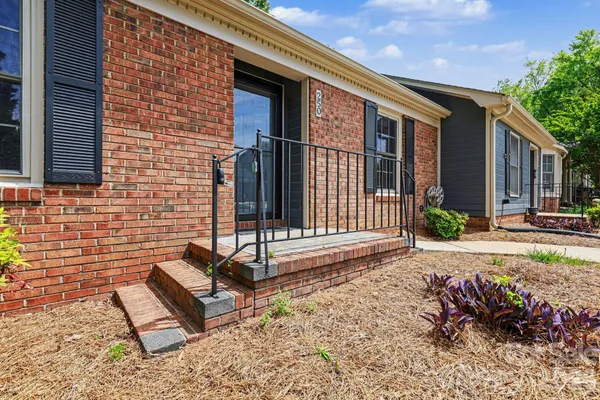 a view of a brick house with a yard