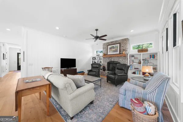 a living room with furniture and a floor to ceiling window