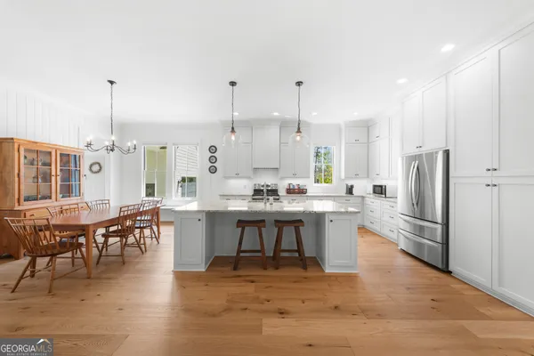 a kitchen with stainless steel appliances granite countertop a sink a stove and a refrigerator
