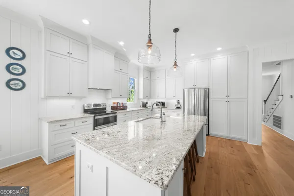 a kitchen with sink stove and cabinets