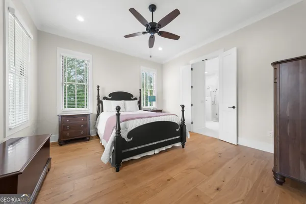 a bedroom with a bed a table and chair