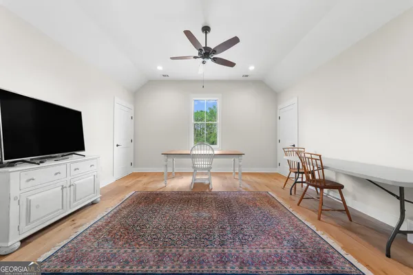 a view of a dining room with furniture and wooden floor