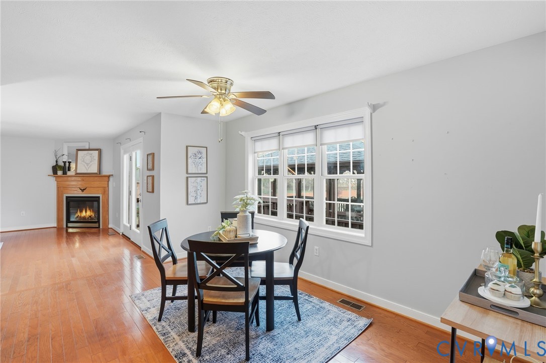 8420 Lee Davis Road Mechanicsville, VA 23116 - Photo 13 of 45 a view of a dining room with furniture and wooden floor