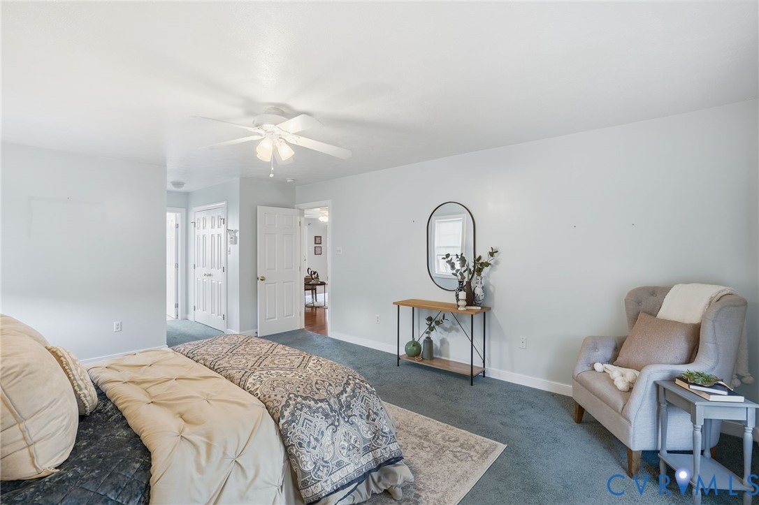 8420 Lee Davis Road Mechanicsville, VA 23116 - Photo 20 of 45 a bedroom with a bed and a chandelier