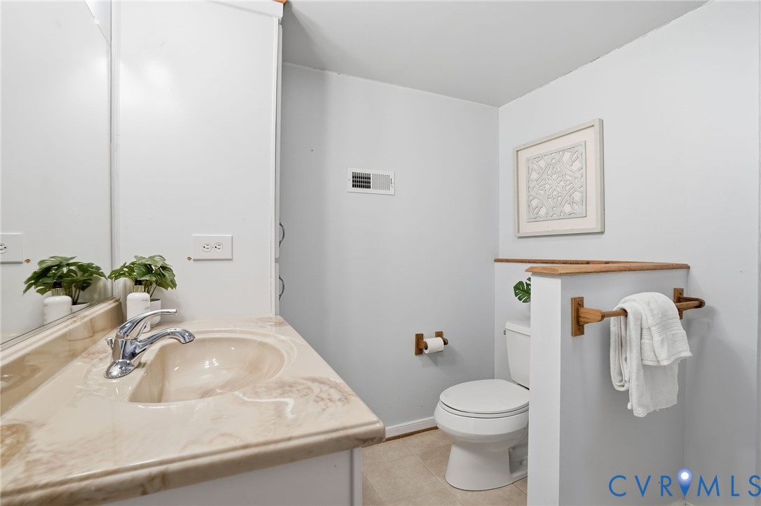 8420 Lee Davis Road Mechanicsville, VA 23116 - Photo 27 of 45 a bathroom with a sink toilet and vanity