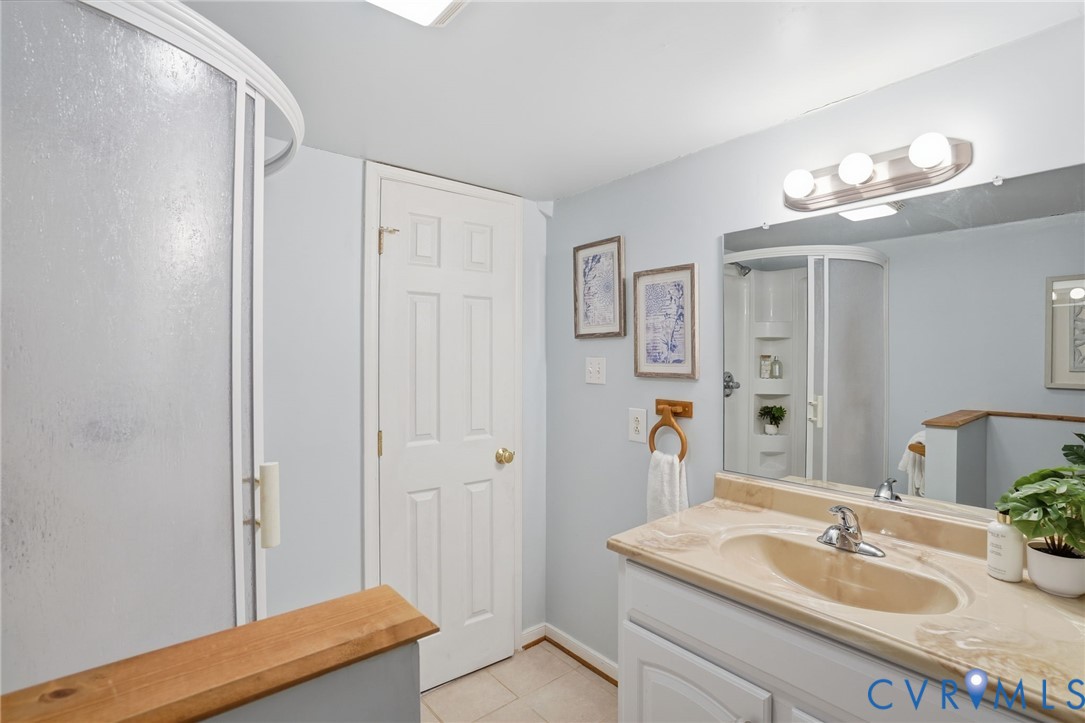 8420 Lee Davis Road Mechanicsville, VA 23116 - Photo 29 of 45 a bathroom with a sink vanity granite tub and shower