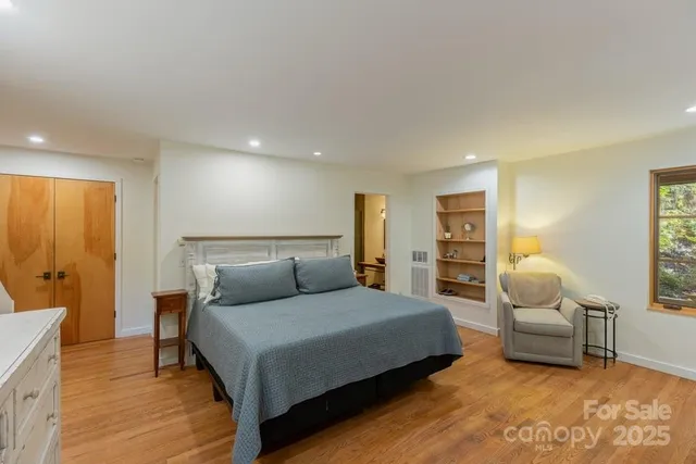 a bedroom with furniture and a lamp