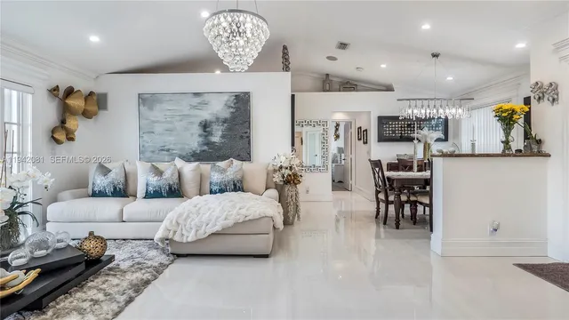 a living room with furniture and a chandelier