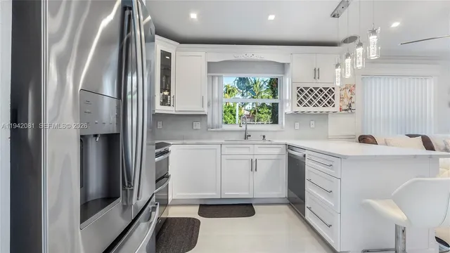 a kitchen with stainless steel appliances a sink stove and refrigerator