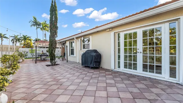 a view of a swimming pool with a lawn chairs under an umbrella