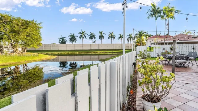 a dining room with furniture and a potted plant