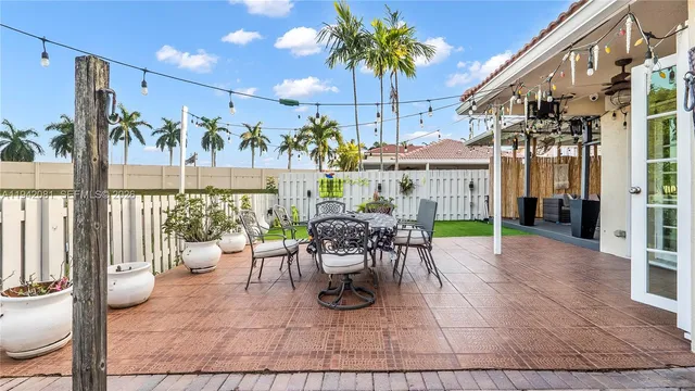 a view of a patio with a table and chairs