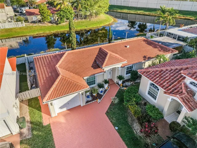 an aerial view of house with yard swimming pool and outdoor seating