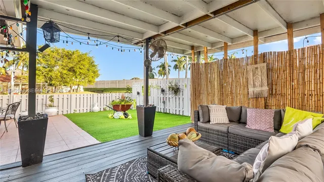 a view of a porch with chairs and backyard