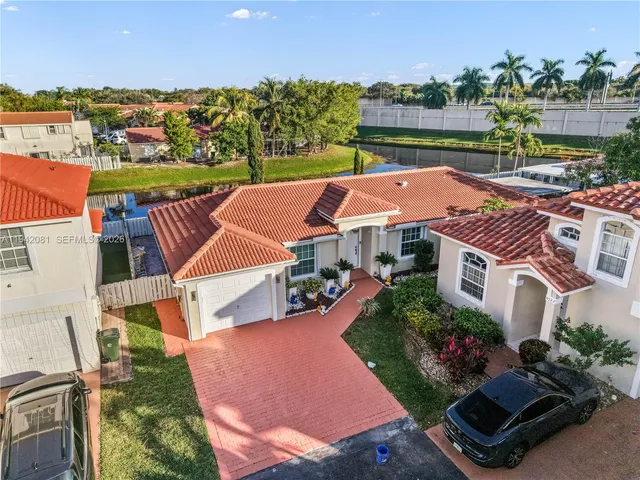 an aerial view of multiple houses with yard