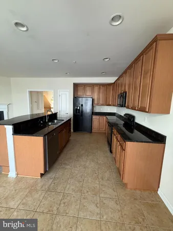 a kitchen with granite countertop a sink and cabinets