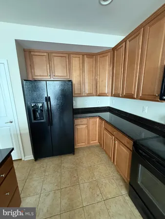 a kitchen with kitchen island a sink stove and cabinets