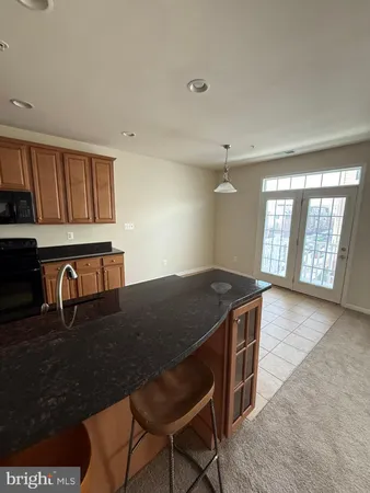 a stove top oven sitting inside of a kitchen