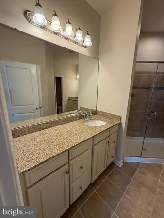 a bathroom with a shower and a sink