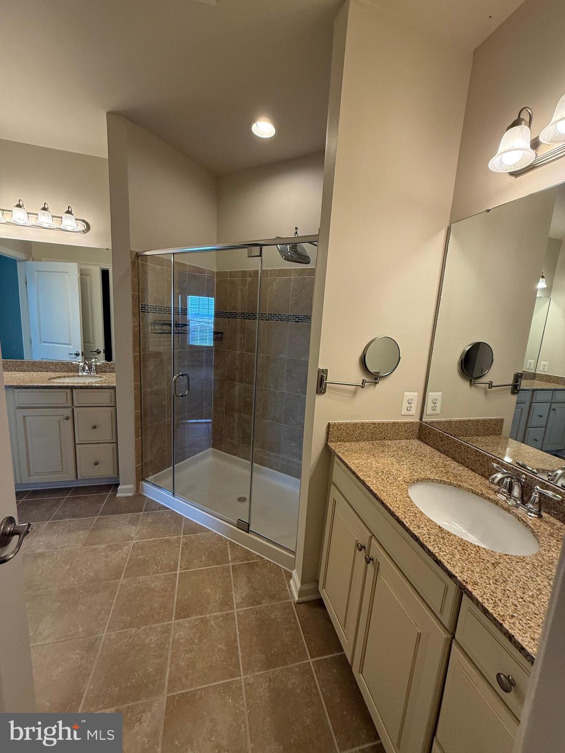 202 B Mill Pond Road Frederick, MD 21701 - Photo 30 of 44 a bathroom with a granite countertop sink a mirror and a shower