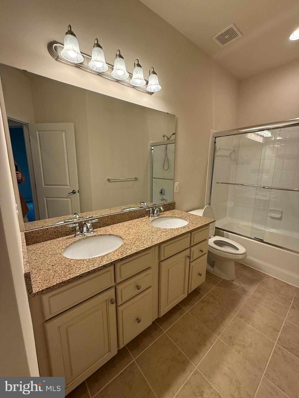 202 B Mill Pond Road Frederick, MD 21701 - Photo 36 of 44 a bathroom with a granite countertop sink a toilet and a mirror