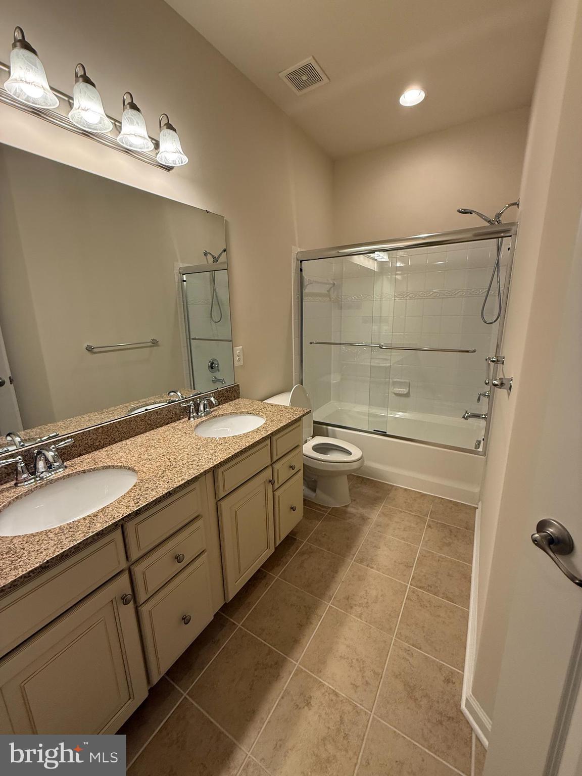 202 B Mill Pond Road Frederick, MD 21701 - Photo 37 of 44 a bathroom with a double vanity sink toilet and shower