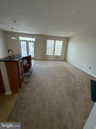 a view of a livingroom with furniture and a window