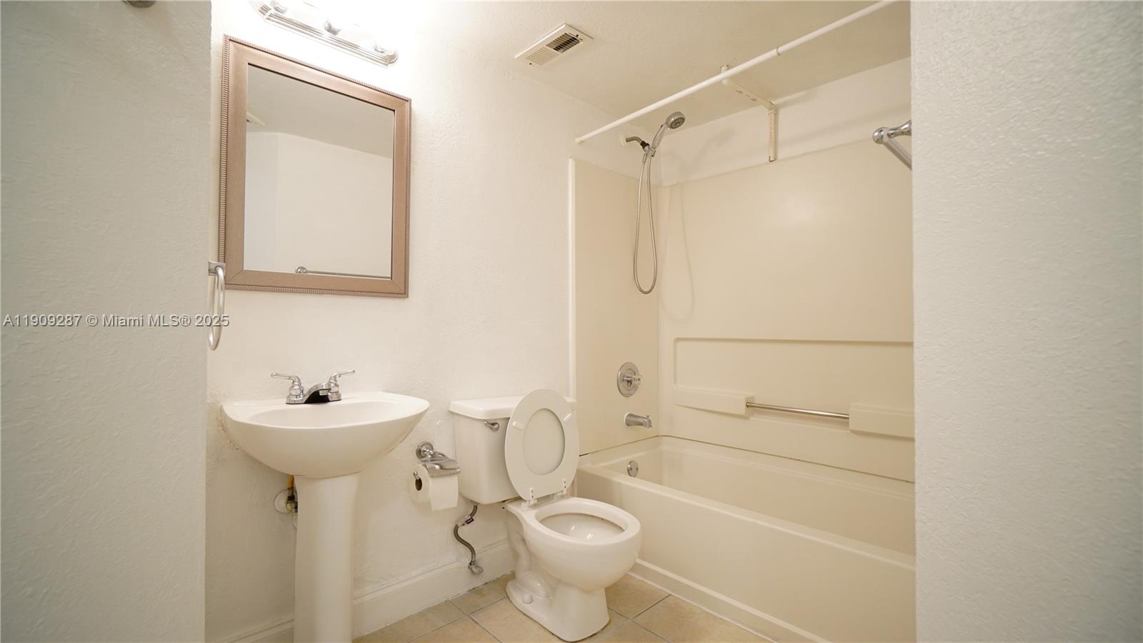 15231 Southwest 80th Street, Unit 101 Miami, FL 33193 - Photo 14 of 19 a bathroom with a sink a toilet and shower