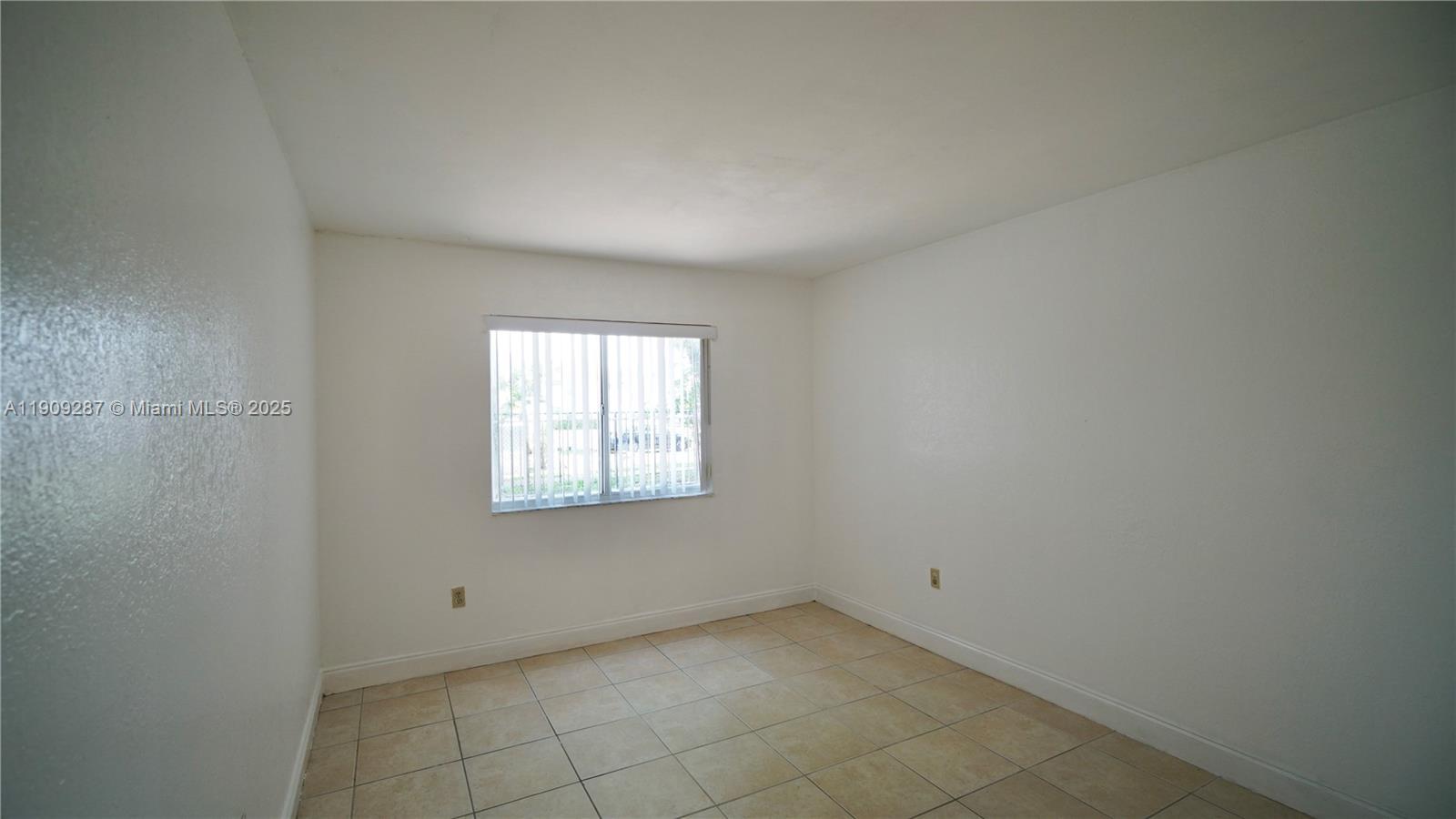 15231 Southwest 80th Street, Unit 101 Miami, FL 33193 - Photo 15 of 19 an empty room with a window
