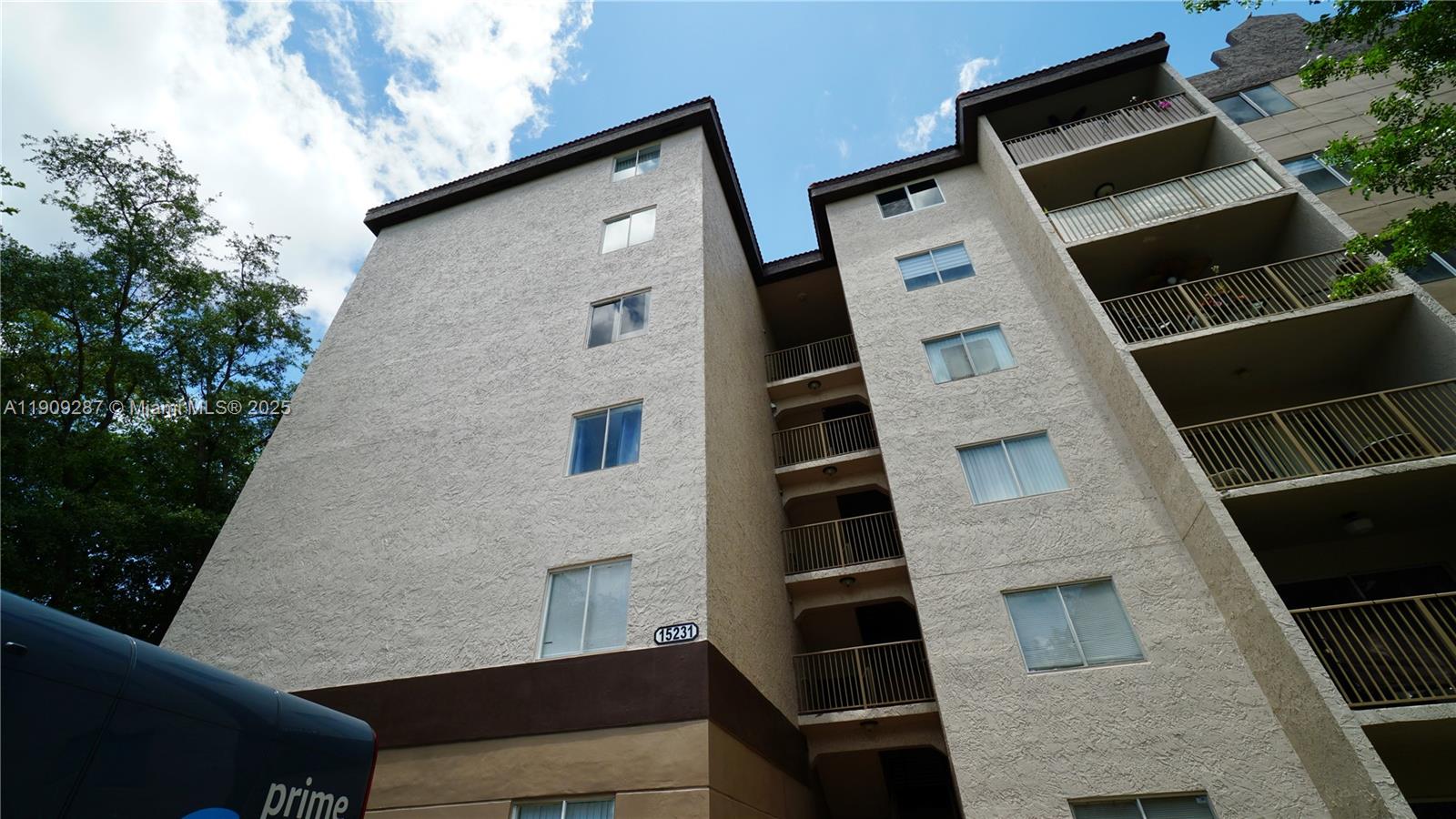 15231 Southwest 80th Street, Unit 101 Miami, FL 33193 - Photo 18 of 19 a front view of a house with large windows
