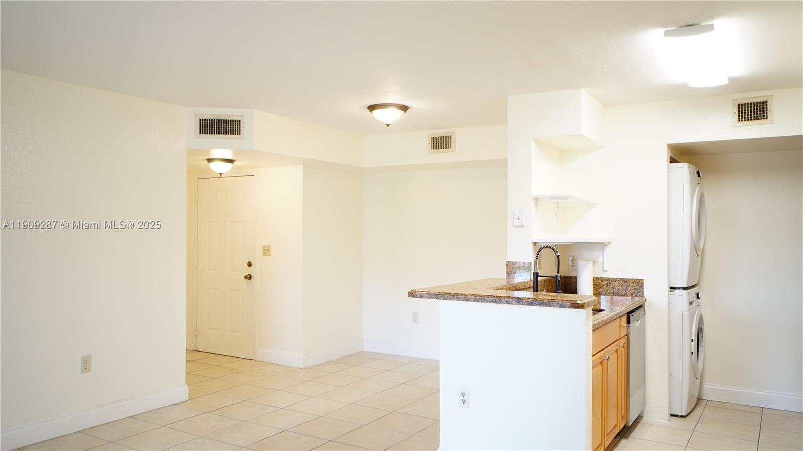 15231 Southwest 80th Street, Unit 101 Miami, FL 33193 - Photo 3 of 19 a kitchen with stainless steel appliances granite countertop a sink and a refrigerator